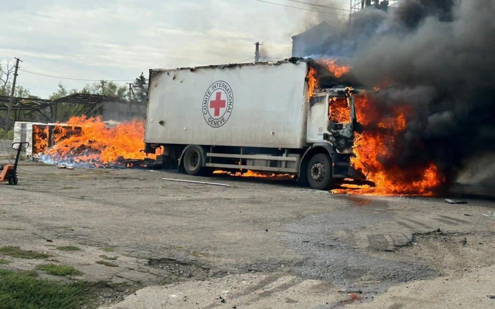 A Red Cross cargo truck burns after an alleged Russian military strike in the Donetsk region