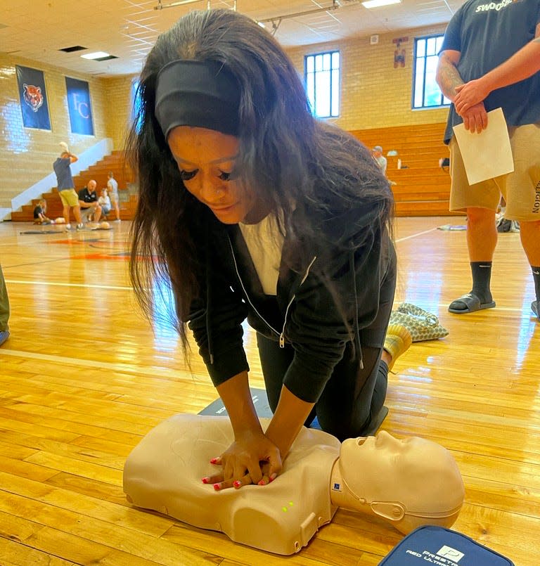 Malayia Little, Ballard's cheer coach, practices CPR during the Jefferson County Public Schools' fall clinic.