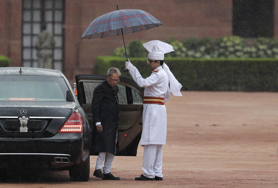 FILE- In this Tuesday, July 25, 2017, file photo, India's former President Pranab Mukherjee arrives for a joint services guard of honour before leaving Presidential palace after swearing in ceremony of new president Ram Nath Kovind in New Delhi, India. Former President Pranab Mukherjee, who was a key troubleshooter in managing fractious coalitions as a member of India's long-governing Congress party died Monday evening. He was 84. Mukherjee had emergency surgery for a blood clot in his brain on August 10 at New Delhi's Army Hospital Research and Referral. (AP Photo/Manish Swarup,file)