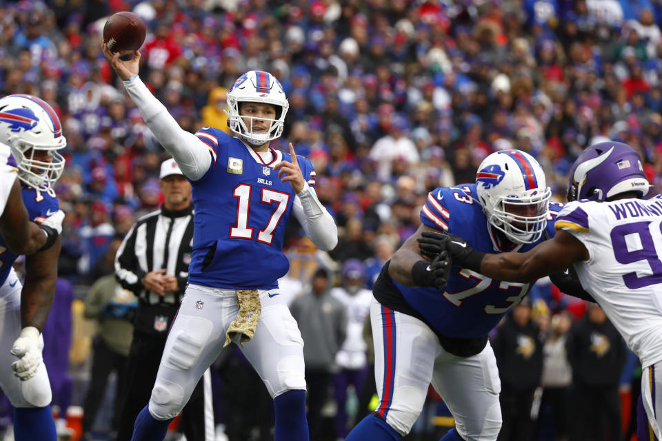 Buffalo Bills quarterback Josh Allen (17) passes under pressure from Minnesota Vikings linebacker D.J. Wonnum, right, as Bills offensive tackle Dion Dawkins (73) defends in the first half of an NFL football game, Sunday, Nov. 13, 2022, in Orchard Park, N.Y. (AP Photo/Jeffrey T. Barnes)