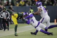 Green Bay Packers' Aaron Jones is stopped by Minnesota Vikings' Patrick Peterson during the first half of an NFL football game Sunday, Jan. 2, 2022, in Green Bay, Wis. (AP Photo/Aaron Gash)