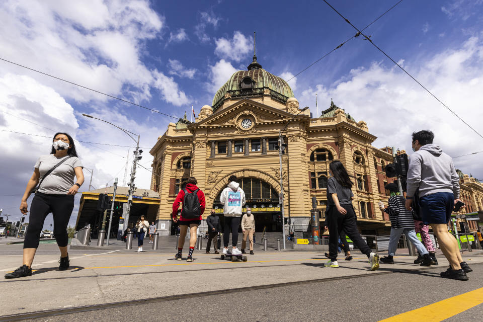 People are seen crossing Flinders Street in Melbourne, Monday, October 4, 2021. Source: AAP