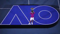 Rafael Nadal of Spain holds the Norman Brookes Challenge Cup after defeating Daniil Medvedev of Russia in the men's singles final at the Australian Open tennis championships in Melbourne, Australia, Sunday, Jan. 30, 2022. (AP Photo/Tertius Pickard)