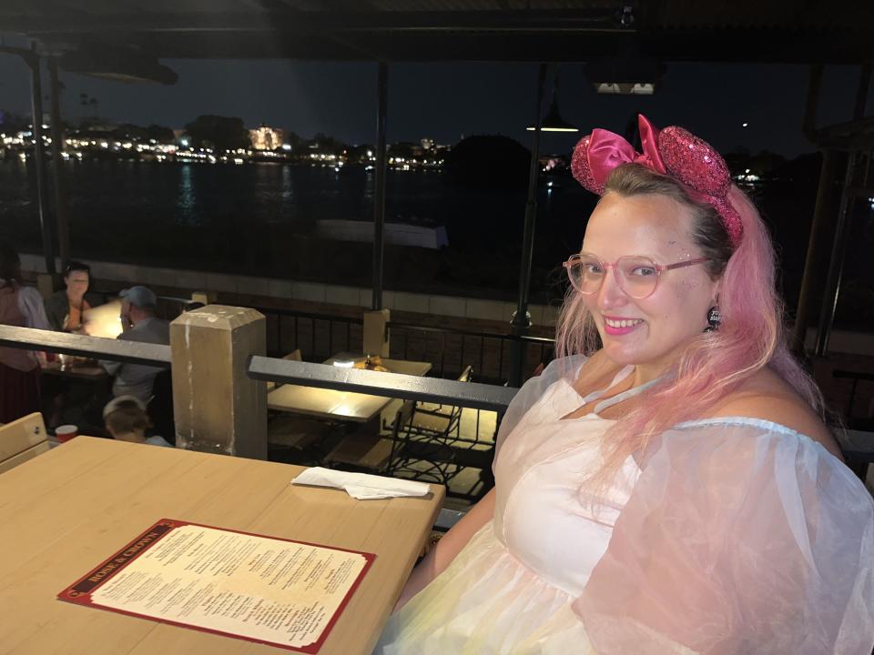 Author sitting at table in outside dining area.