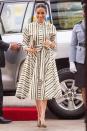 <p>Meghan kicked off her second day in Tonga wearing a striped dress by Martin Grant. She finished her outfit off with a clutch by Prada and green heels. </p>