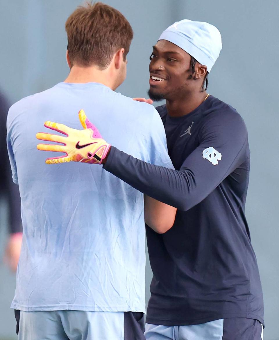 Wide receiver Tez Walker, right and quarterback Drake Maye, left, embrace after Walker caught a deep pass from Maye during the Carolina Football Pro Day at UNC Chapel Hill’s Koman Indoor Practice Facility on Thursday, March 28, 2024. JEFF SINER/jsiner@charlotteobserver.com