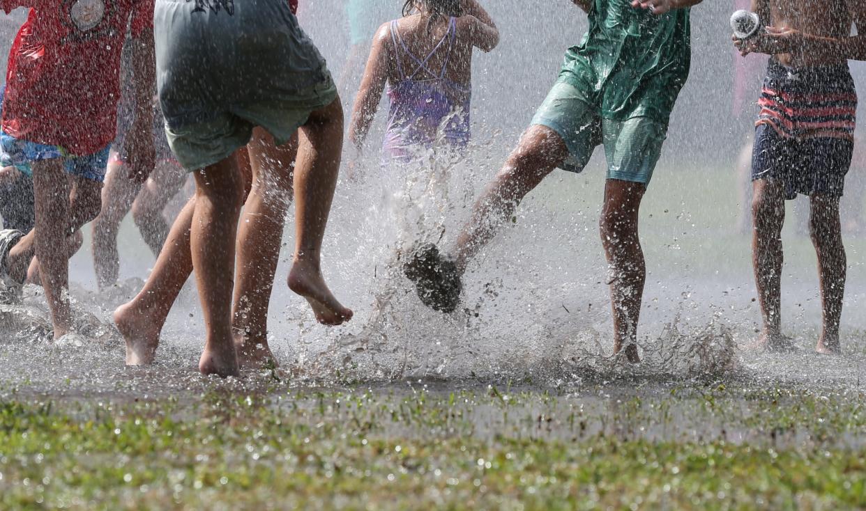 Children splash and play during the Richmond Hill Fire Department's first pop up splash pad of the summer at JF Gregory Park in Richmond Hill on Friday, June 14, 2024.
