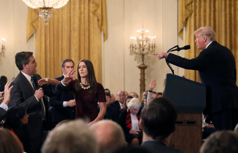 A White House staff member reaches for the microphone held by CNN’s Jim Acosta as he questions President Trump during a news conference at the White House, Nov. 7, 2018. (Photo: Jonathan Ernst/Reuters)