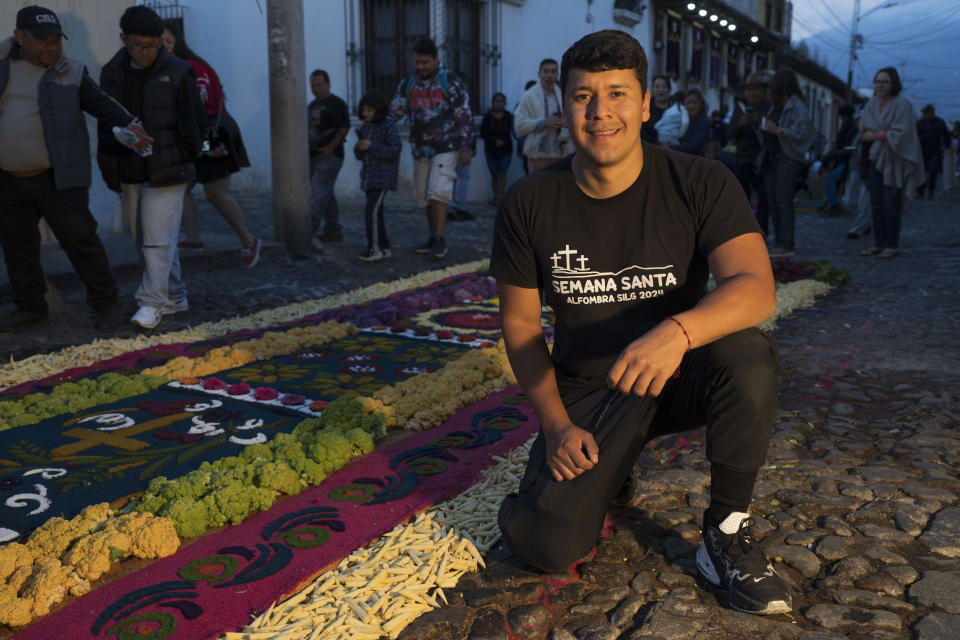 Ivan Lemus poses for a photo next to his very first sawdust carpet, prior to a Holy Week procession in Antigua, Guatemala, on Good Friday, March 29, 2024. (AP Photo/Moises Castillo)