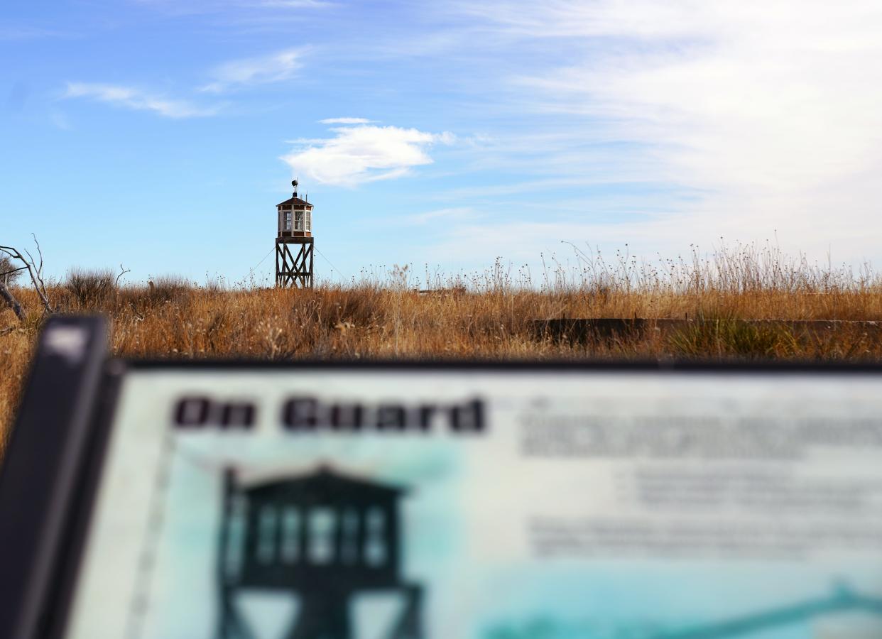 A reconstructed octagonal guard tower looms over a sign at the Amache site in Grenada, Colorado, where about 7,500 Japanese Americans, most of them U.S. citizens, were forcibly detained without due process during WWII.