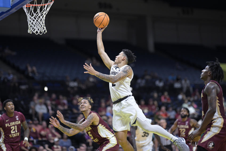 Colorado guard KJ Simpson goes up for a shot as Florida State guard Cam'Ron Fletcher, forward De'Ante Green and forward Jamir Watkins, right, watch during the first half of an NCAA college basketball game, Tuesday, Nov. 21, 2023, in Daytona Beach, Fla. (AP Photo/Phelan M. Ebenhack)