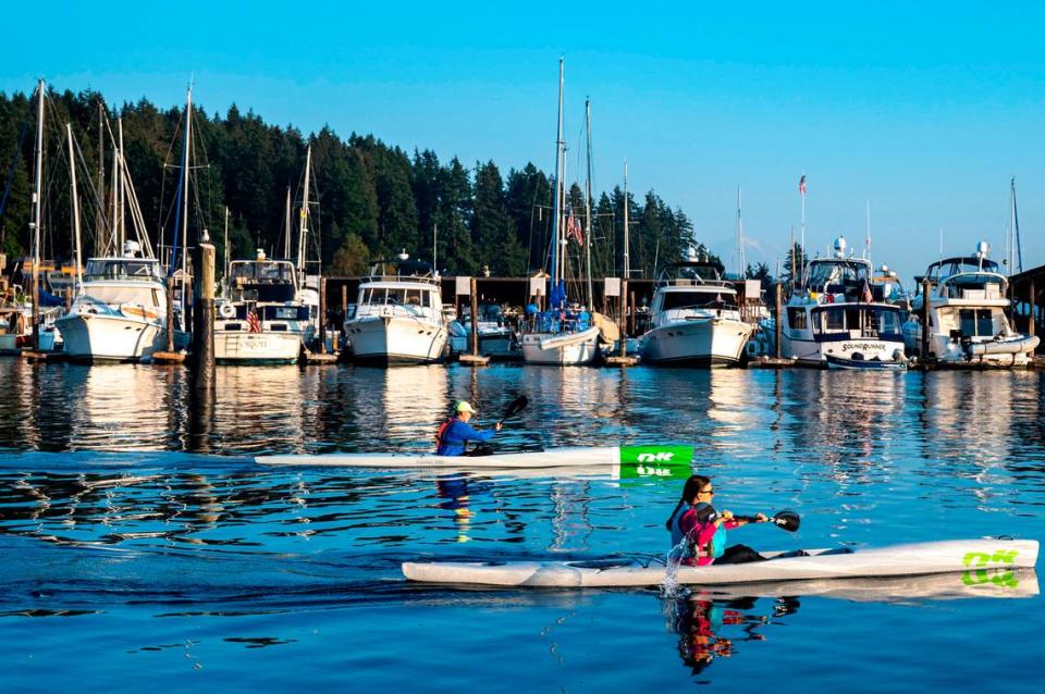 Kayakers paddle through the calm waters of Gig Harbor on Wednesday, Oct. 12, 2022. Even though summer has seemed to last longer than usual rain is forecasted throughout the South Puget Sound Area in the coming week.