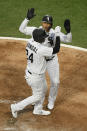 Chicago White Sox's Yasmani Grandal (24) celebrates with Yermín Mercedes at home plate after hitting a three-run home run during the second inning of the team's baseball game against the Minnesota Twins on Tuesday, May 11, 2021, in Chicago. (AP Photo/Paul Beaty)
