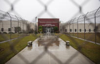 The Stewart Detention Center is seen through the front gate, Friday, Nov. 15, 2019, in Lumpkin, Ga. The rural town is about 140 miles southwest of Atlanta and next to the Georgia-Alabama state line. The town’s 1,172 residents are outnumbered by the roughly 1,650 male detainees that U.S. Immigration and Customs Enforcement said were being held in the detention center in late November. (AP Photo/David Goldman)