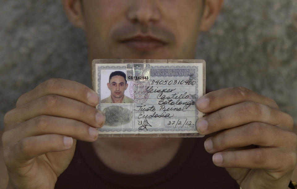 In this Feb. 19, 2014 photo, Yeisker Castillo poses for a photo holding up his identification card in Havana, Cuba. Castillo is part of Cuba’s so-called Generation Y, the thousands upon thousands of islanders born during the Cold War whose parents turned tradition on its ear by giving them invented monikers inspired by Russian names like Yevgeny, Yuri or Yulia. More than two decades after the fall of the Iron Curtain, Cubans are increasingly returning to more traditional handles for their kids, saying they believe it will better suit them personally and professionally when they grow up. (AP Photo/Franklin Reyes)