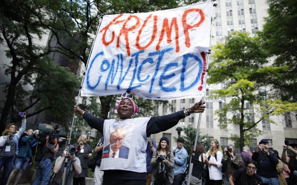 People react after former US President and Republican presidential candidate Donald Trump was convicted in his criminal trial outside of Manhattan Criminal Court