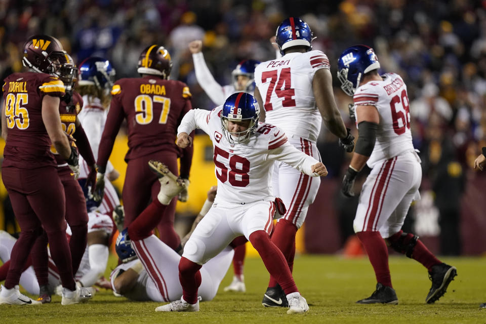 New York Giants long snapper Casey Kreiter (58) celebrates a field goal by teammate Graham Gano during the second half of an NFL football game against the Washington Commanders, Sunday, Dec. 18, 2022, in Landover, Md. (AP Photo/Patrick Semansky)