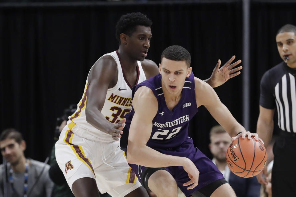 Northwestern's Pete Nance (22) works the ball against Minnesota's Isaiah Ihnen (35) during the first half of an NCAA college basketball game at the Big Ten Conference tournament, Wednesday, March 11, 2020, in Indianapolis. (AP Photo/Darron Cummings)
