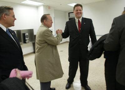 In this 2003 photo Jack McGreevey congratulates Carteret's 26 year old mayor-elect , Daniel J. Reiman, upon seeing him before the start of the reorganization meeting at the Deverin Center. Then U.S. Rep. Bob Menendez watches on at left.