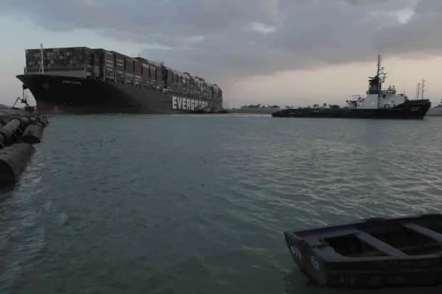 In this photo released by the Suez Canal Authority, tug boats work to free the Panama-flagged, Japanese-owned Ever Given, which was lodged across the Suez Canal last month. The ship's operator, Evergreen Marine Corp., is a major Taiwan-based shipping company.