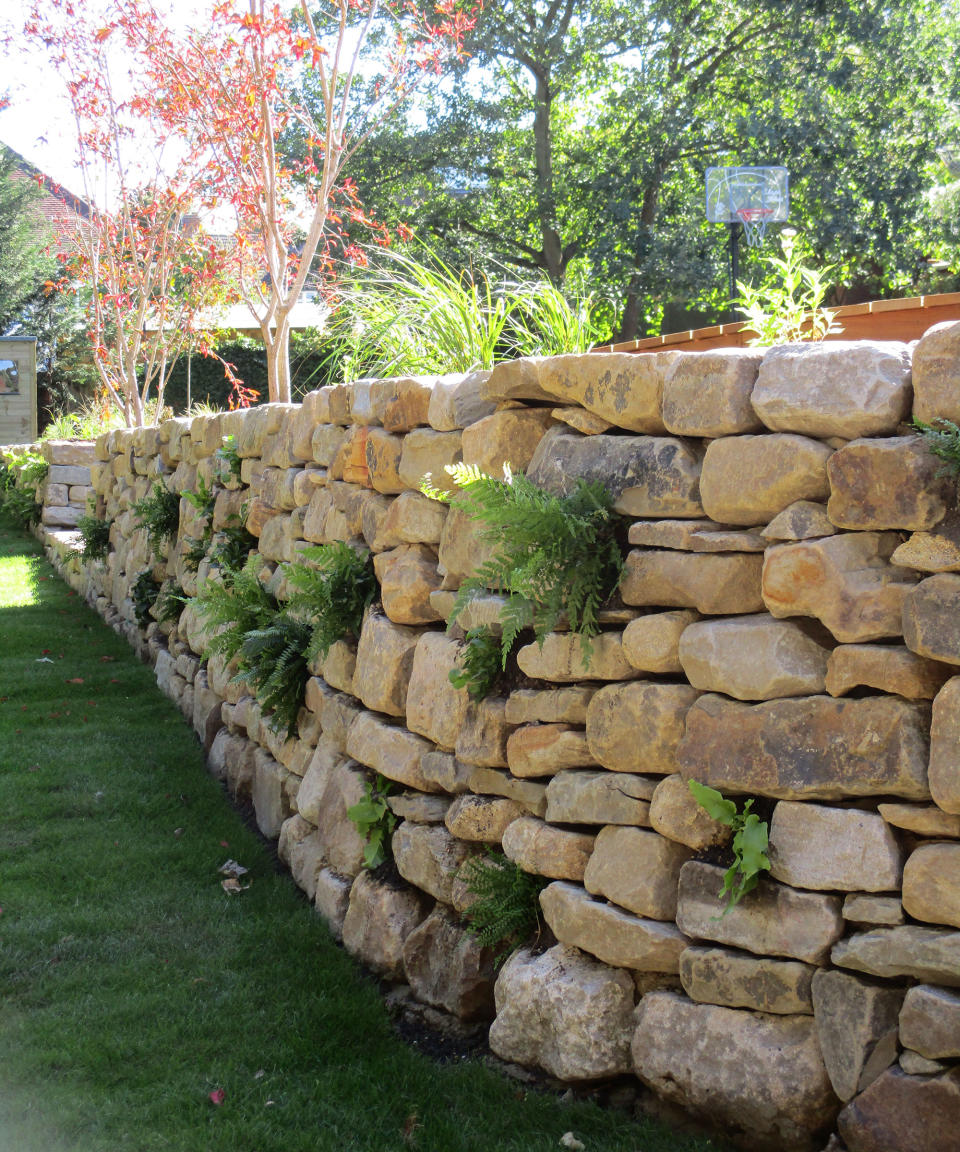<p> Creating stone garden wall ideas that appear to have been there for generations requires care and attention to detail. As well as creating a stunning feature that&#x2019;s full of character it can quickly become home to insects, tiny mammals and wild birds, encouraging biodiversity and pollinators to flourish.&#xA0; </p> <p> &apos;In this project, we created a natural wildlife garden using sustainable materials and biodiverse flora,&apos; explains landscape designer Amir Schlezinger of Mylandscapes. &apos;The stone was reclaimed from an old farmyard and was used to retain the existing gradient and made to look as if it&apos;s always been there. We introduced a broad palette of native plants too. Within the wall, which is shaded, we left gaps in the stone for crevice planting of ferns, Campanula and Ajuga. Once established in the first year by additional watering, this naturalistic planting is low maintenance. Using a semi-dry wall technique, construction was swift and cost-effective.&apos; </p>