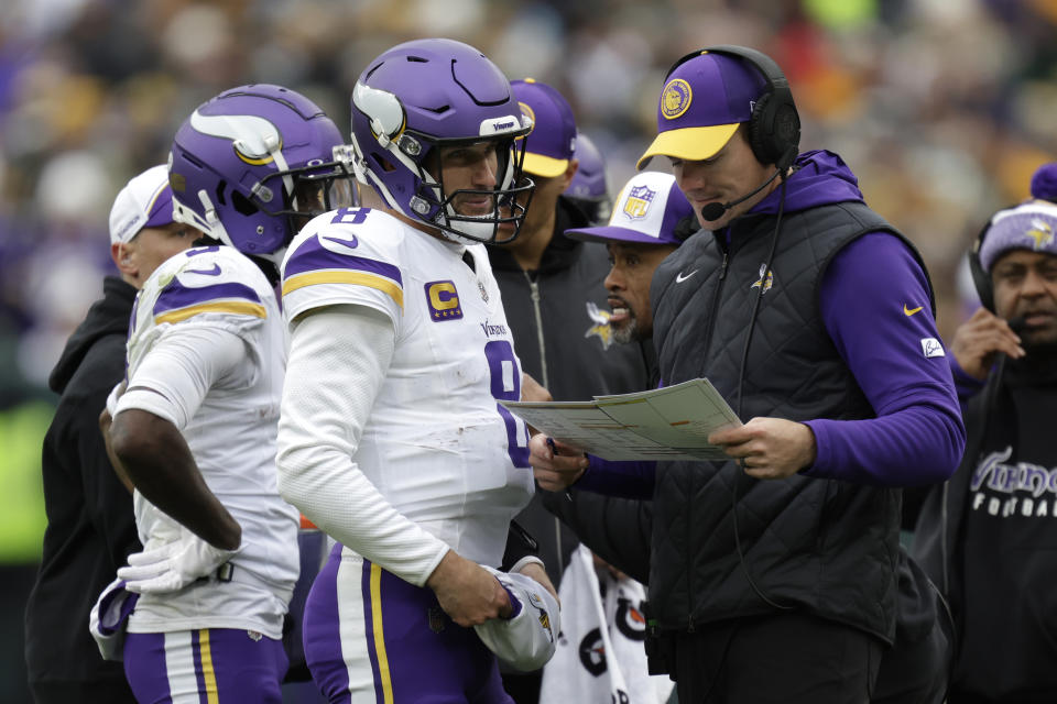 Minnesota Vikings quarterback Kirk Cousins (8) talks with head coach Kevin O'Connell, right, during the first half of an NFL football game against the Green Bay Packers, Sunday, Oct. 29, 2023, in Green Bay, Wis. (AP Photo/Matt Ludtke)