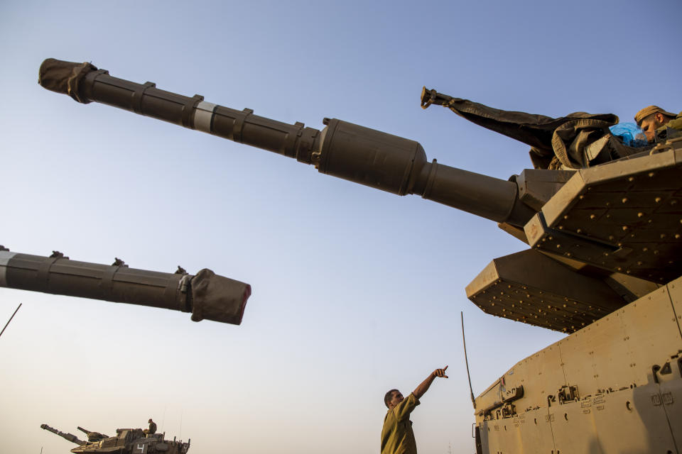 Israeli soldiers work on tanks in the Israeli-controlled Golan Heights near the border with Syria, not far from Lebanon border, Tuesday, July 28, 2020. Lebanon's prime minister has accused Israel of provoking a "dangerous escalation" along the border in an attempt to modify the mandate of a U.N. peacekeeping force in south Lebanon. (AP Photo/Ariel Schalit)