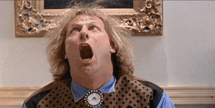 Jeff Daniels in a comedic scene from the movie "Dumb and Dumber," with his mouth wide open, looking up
