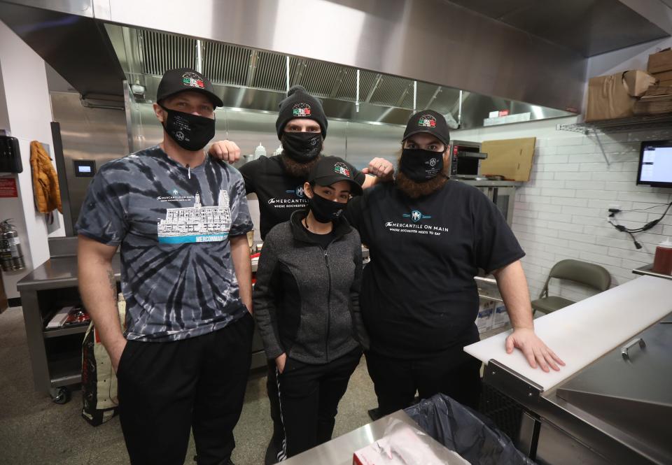 Michael Shoaf, left, brothers Ramon and Fredo Arguinzoni and Erika Rivera, in front, are owners of Palermo's Market at Mercantile on Main inside Sibley Square.