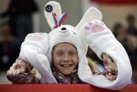 A young skating fan waits for the start of the men's 1000-meter speedskating race at the Adler Arena Skating Center during the 2014 Winter Olympics, Wednesday, Feb. 12, 2014, in Sochi, Russia. (AP Photo/Matt Dunham)