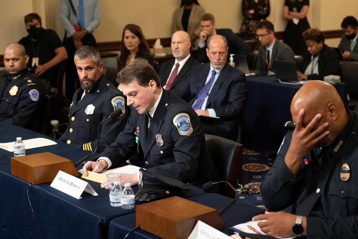 Aquilino Gonell, sergeant of the U.S. Capitol Police, Michael Fanone, officer for the Metropolitan Police Department, and Harry Dunn, private first class of the U.S. Capitol Police, listen while Daniel Hodges, officer for the Metropolitan Police Department, testifies during a hearing of the House select committee investigating the Jan. 6 attack on Capitol Hill in Washington, U.S., July 27, 2021. (Brendan Smialowski/Pool via Reuters)