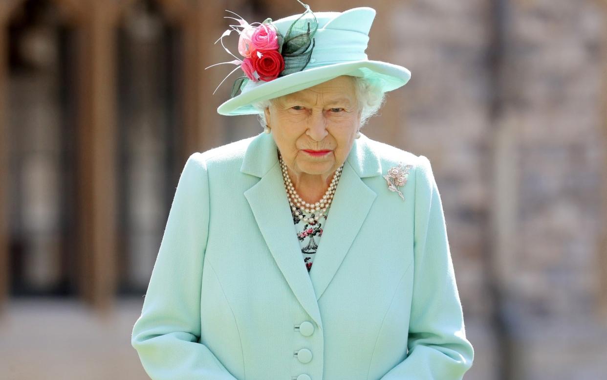 FILE PHOTO: Britain's Queen Elizabeth poses after awarding Captain Tom Moore with the insignia of Knight Bachelor at Windsor Castle, in Windsor, Britain July 17, 2020.  - Chris Jackson/REUTERS