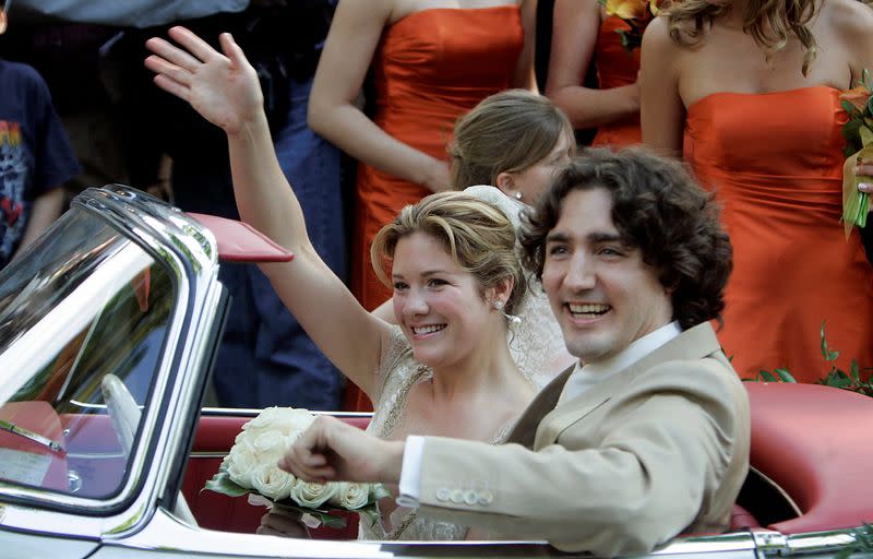 FILE PHOTO: Justin Trudeau and new bride Sophie Gregoire wave as drive off following wedding ceremony.