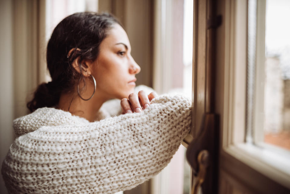 A woman stares out of her window