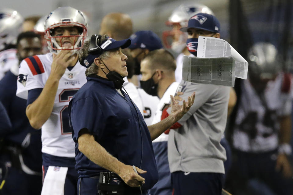 FILE - New England Patriots head coach Bill Belichick catches a packet of papers after he tossed them in the air during the second half of an NFL football game against the Seattle Seahawks in Seattle, in this Sunday, Sept. 20, 2020, file photo. Belichick never was one to spent wildly in free agency. Watching Tom Brady win another Super Bowl in another city sure changed that. The New England Patriots doled out $175 million in guarantees in the first 48 hours of free agency following a 7-9 stumble in 2020 that officially ended their two-decade dominance of the AFC. (AP Photo/John Froschauer, File)