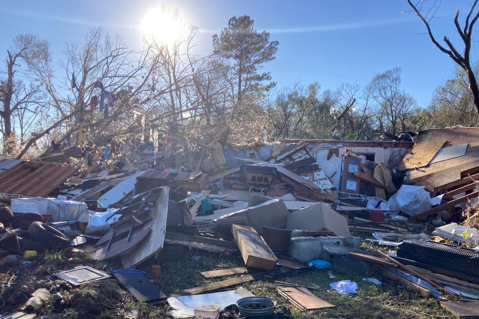 Debris is piled up following severe weather Wednesday, Dec. 14, 2022, in Keithville, La. A volatile storm ripping across the U.S. spawned tornadoes that killed a young boy and his mother in Louisiana, smashed mobile homes and chicken houses in Mississippi and threatened neighboring Southern states with more punishing weather Wednesday. (AP Photo/Jake Bleiberg)