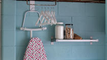 Include a hanger for the ironing board and shelving for extra items.