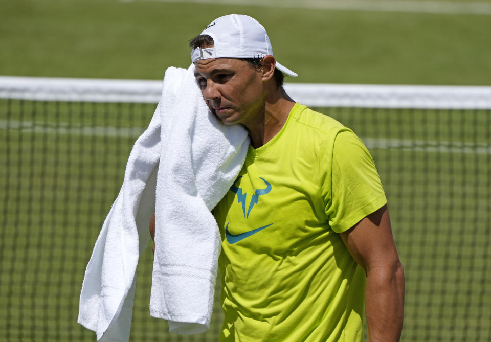 Spain's Rafael Nadal wipes his face with a towel as he practices ahead of the Wimbledon tennis championships in London, Sunday, June 26, 2022. (AP Photo/Alastair Grant)