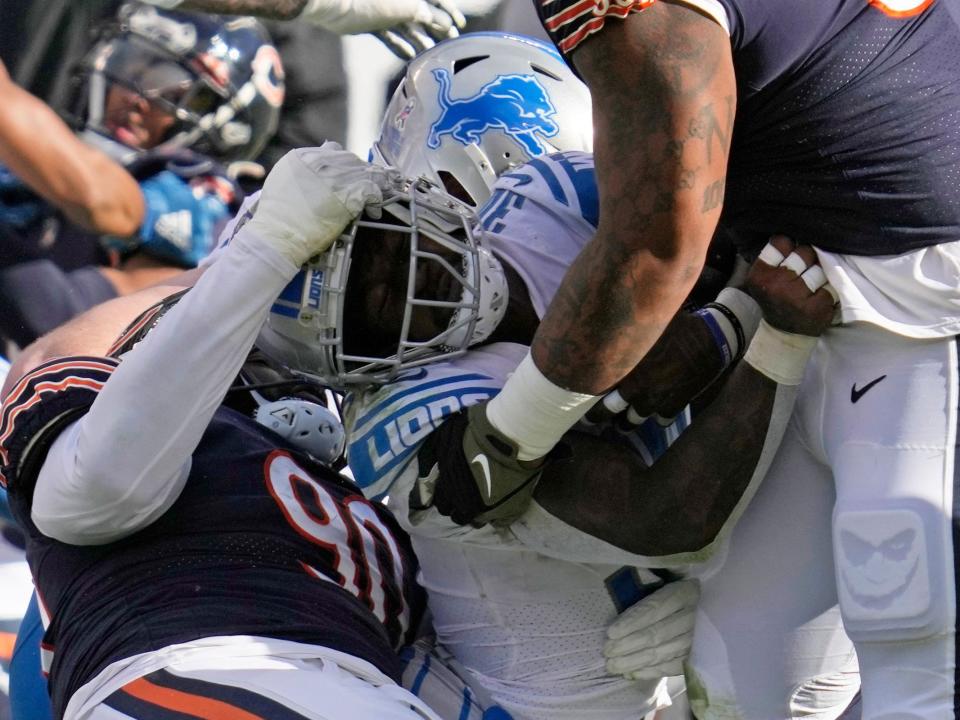 Jamaal Williams is tackled by the Bears defense.