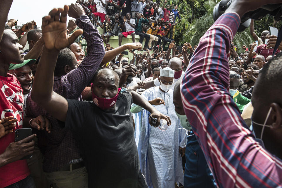 Guinean opposition leader Cellou Dalein Diallo, centre, walks by supporters at his headquarters in Conakry, Guinea, Monday Oct. 19, 2020. Diallo declared himself the winner after the country held an election on Sunday with Guinean President Alpha Conde seeking to extend his decade in power. (AP Photo/Sadak Souici)