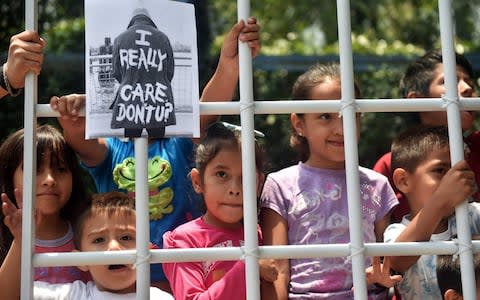 Children take part in a protest against US immigration policies outside the US embassy in Mexico City - Credit: RODRIGO ARANGUA/AFP