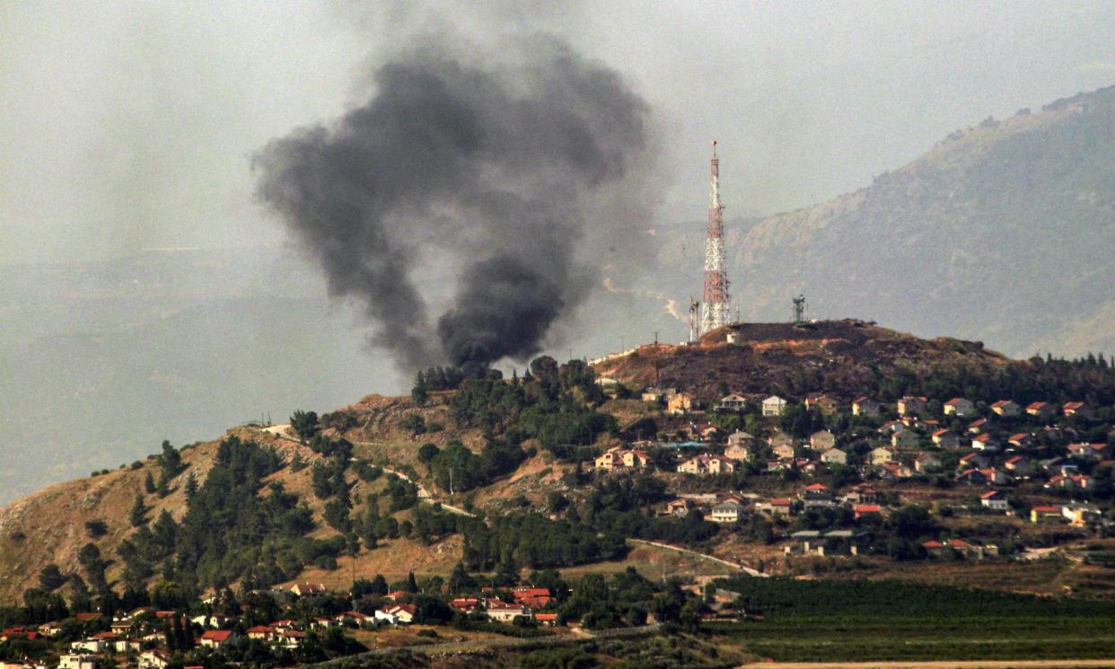 <span>Smoke rises over Metula, northern Israel, on 14 June after a Lebanese rocket attack.</span><span>Photograph: Rabih Daher/AFP/Getty Images</span>