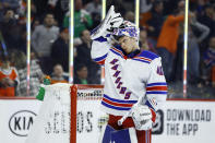 New York Rangers' Alexandar Georgiev adjusts his mask after giving up a goal to Philadelphia Flyers' Claude Giroux during the second period of an NHL hockey game, Friday, Feb. 28, 2020, in Philadelphia. (AP Photo/Matt Slocum)