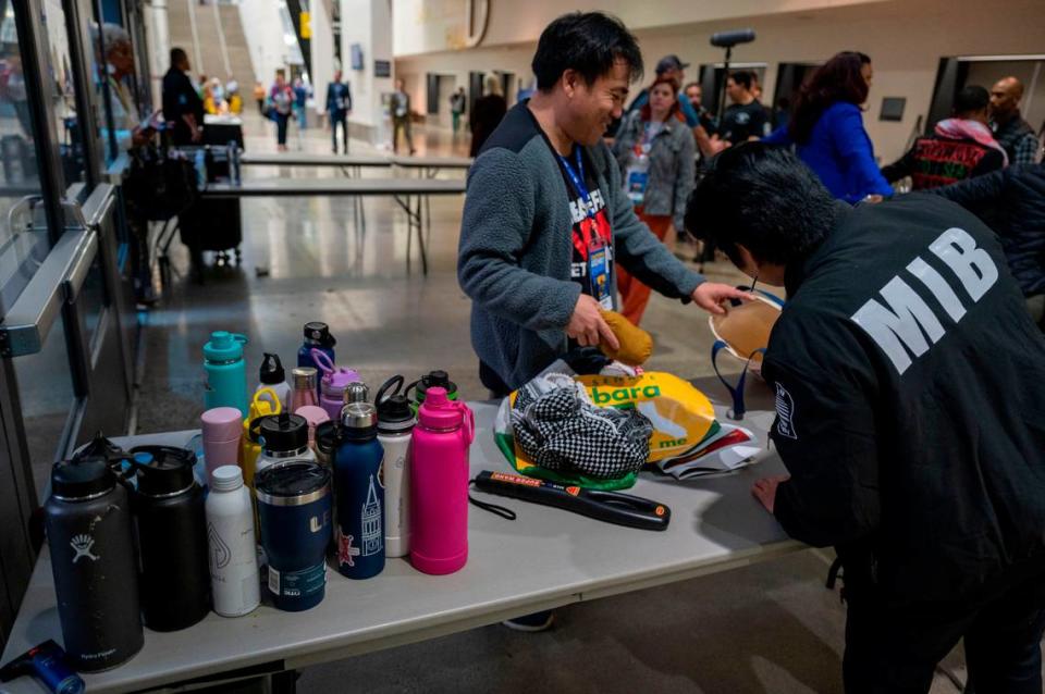 Reusable water bottles are held at a security check point at the entrance of the 2023 California Democratic Party November State Endorsing Convention on Saturday at SAFE Credit Union Convention Center in Sacramento.