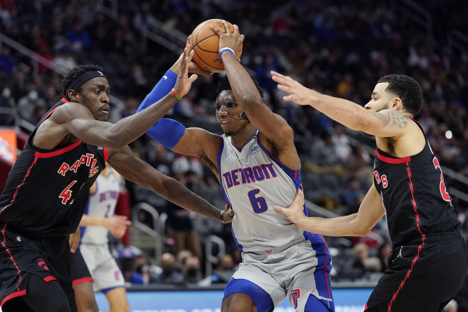 Detroit Pistons guard Hamidou Diallo (6) drives as Toronto Raptors forward Pascal Siakam, left, and guard Fred VanVleet defend during the first half of an NBA basketball game, Friday, Jan. 14, 2022, in Detroit. (AP Photo/Carlos Osorio)