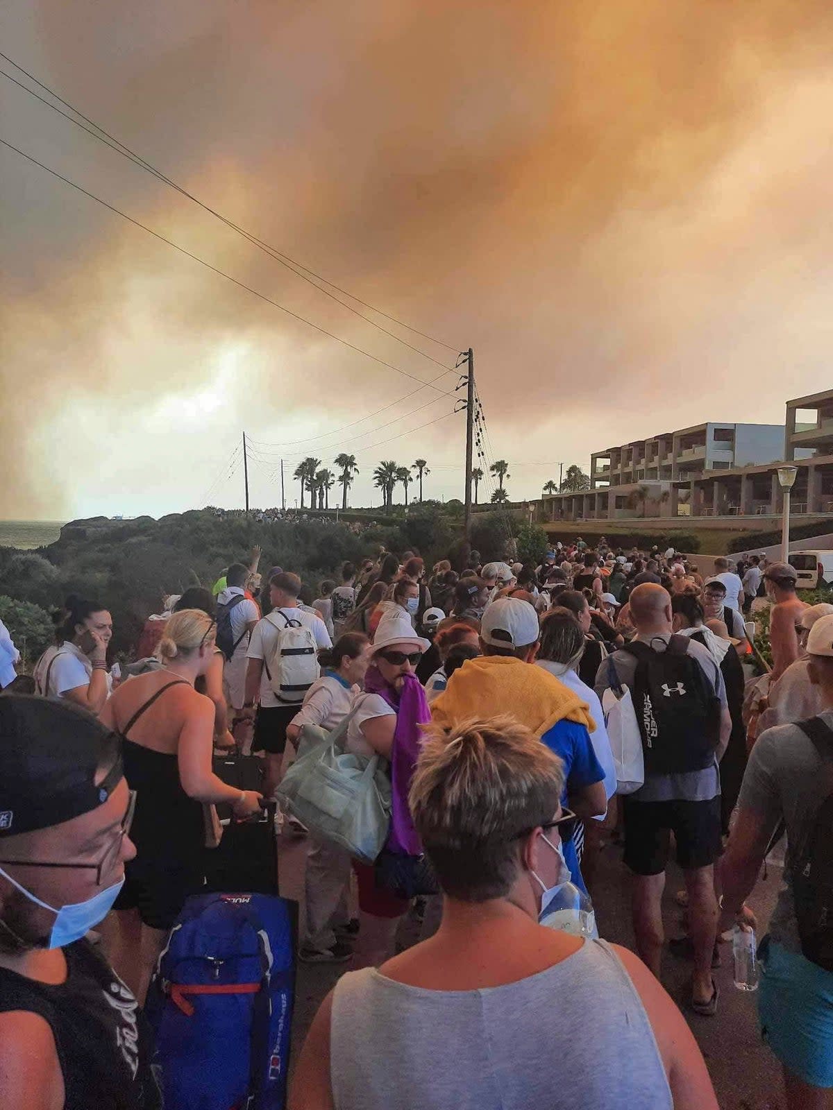 Tourists are evacuated from hotels during a wildfire on Rhodes on July 22 (Eurokinissi/AFP via Getty Images)