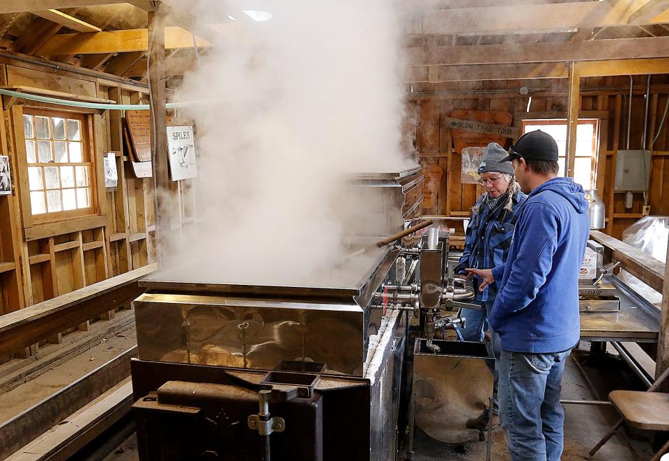 Jon Britton and Kiristin Brubach boil the sap from the maple trees to extract the maple syrup in the Malabar Farm Sugar Shack Tuesday, Feb. 21, 2023. TOM E. PUSKAR/ASHLAND TIMES-GAZETTE
