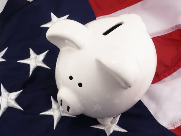 Piggy bank sitting on American flag
