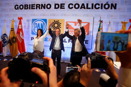 (L to R) President of the Democratic Revolution Party (PRD) Alejandra Barrales, Ricardo Anaya, presidential candidate for the National Action Party (PAN) leading the left-right coalition, and Miguel Angel Mancera, former mayor of Mexico City and the present national coordinator for the left-right coalition, gesture during an event in Mexico City, Mexico, March 28, 2018. REUTERS/Carlos Jasso