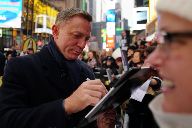 Actor Daniel Craig signs autographs during a promotional appearance on TV in Times Square for the new James Bond movie "No Time to Die" in the Manhattan borough of New York City